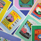 Collection of colourful product labels from various brands on a multicolored background