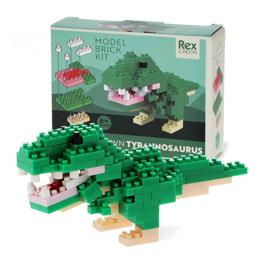 Green model brick kit of a Tyrannosaurus Rex in front of its packaging