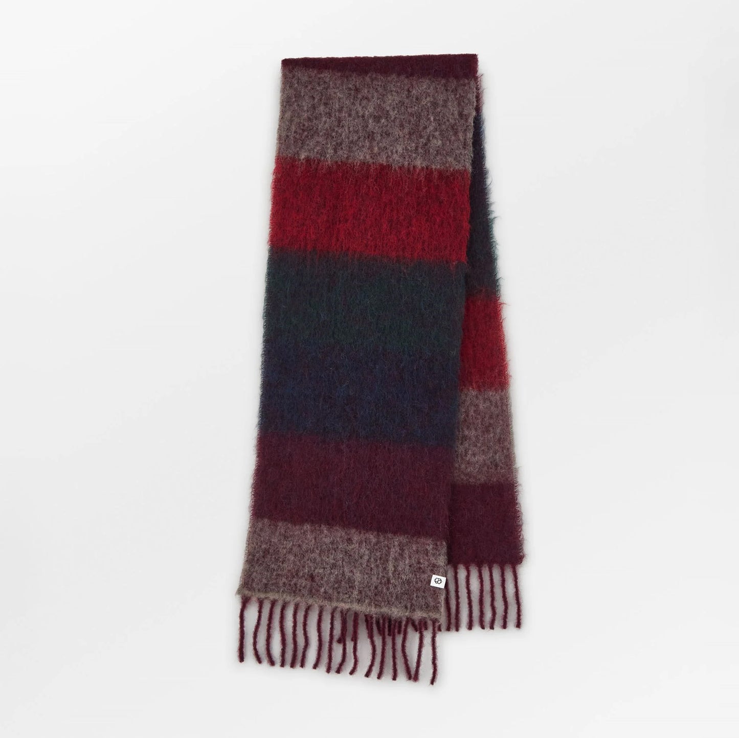 Red, blue and mauve scarf with fringes on a white background