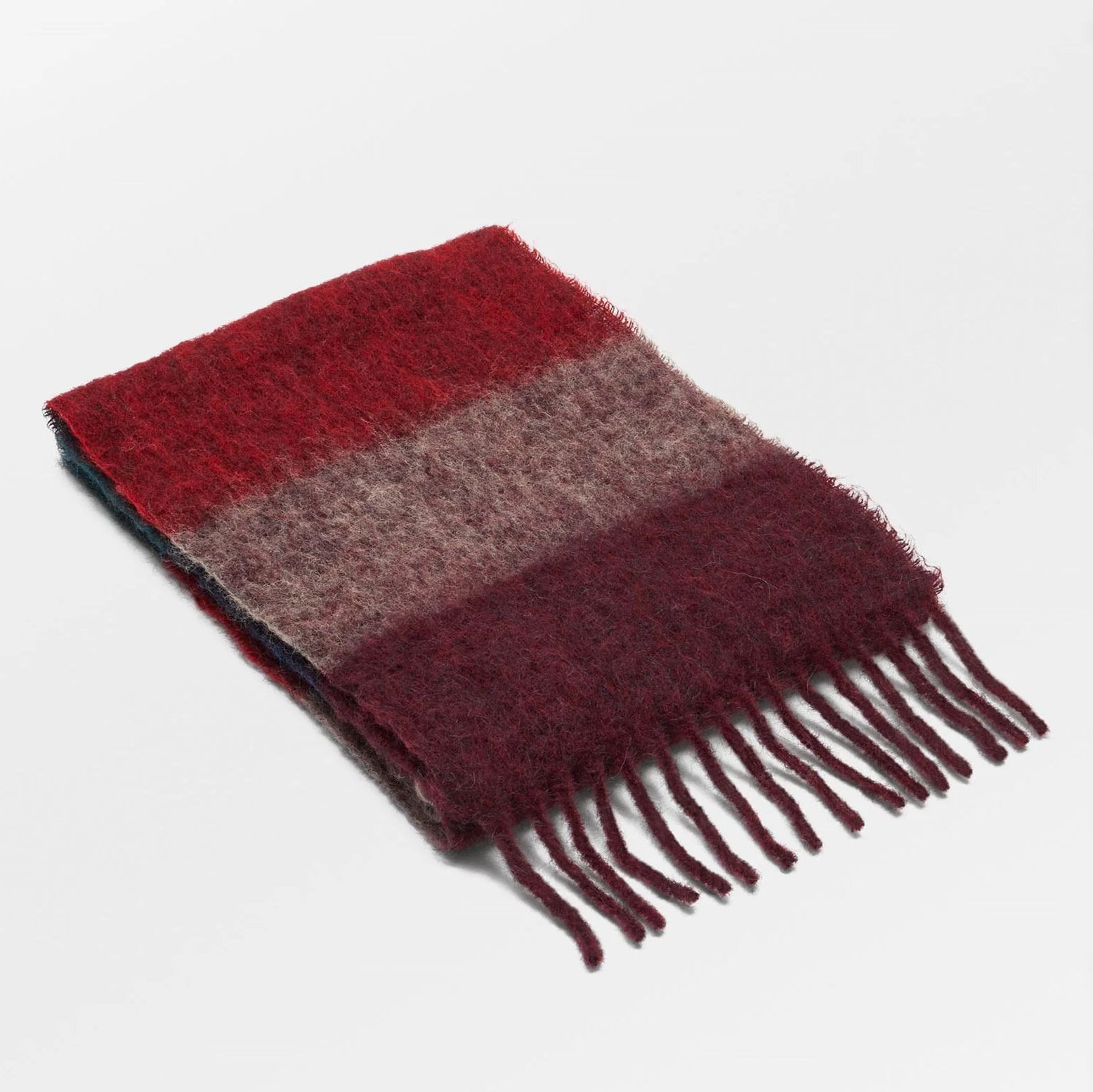 Woolen scarf with red and brown stripes on a light gray background