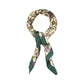 Floral patterned scarf with green accents on a white background