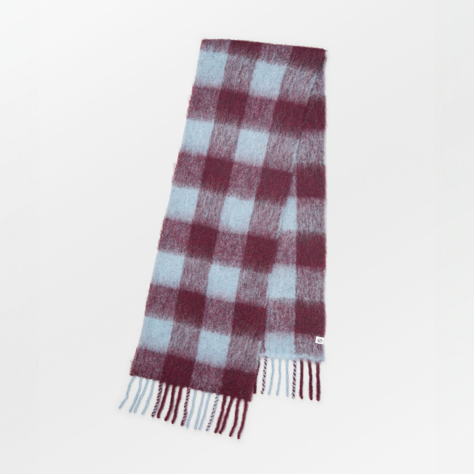 Becksöndergaard Violets Purple Check Mincho Scarf featuring a classic checkered design in rich purple and pastel tones, crafted from luxurious Italian wool, displayed elegantly on a neutral background.