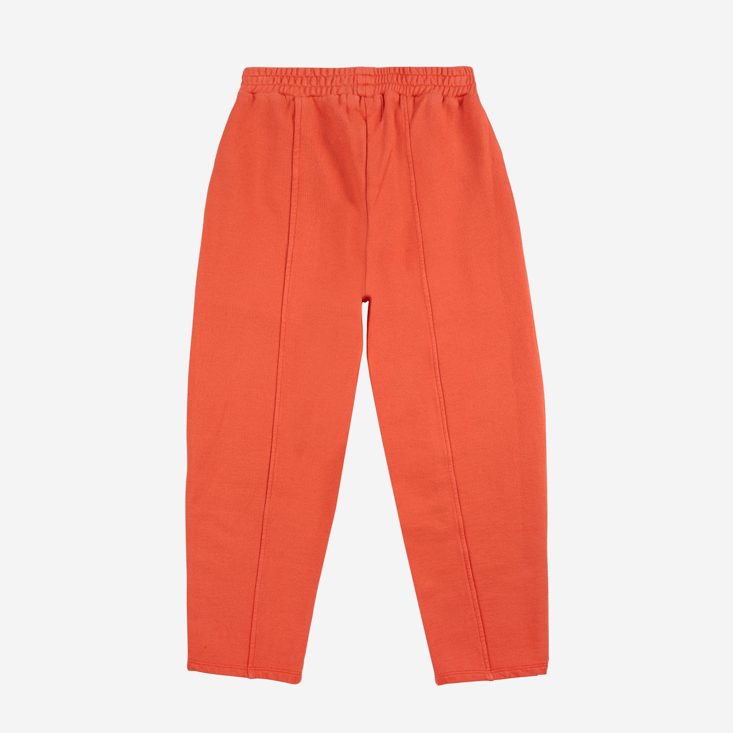 A back view of pair of bright orange children’s sweatpants laid flat against a white background. They feature an elasticated waistband and visible stitched seams running down the back