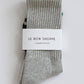 Pair of gray socks with a 'Le Bon Shoppe' label on a white background