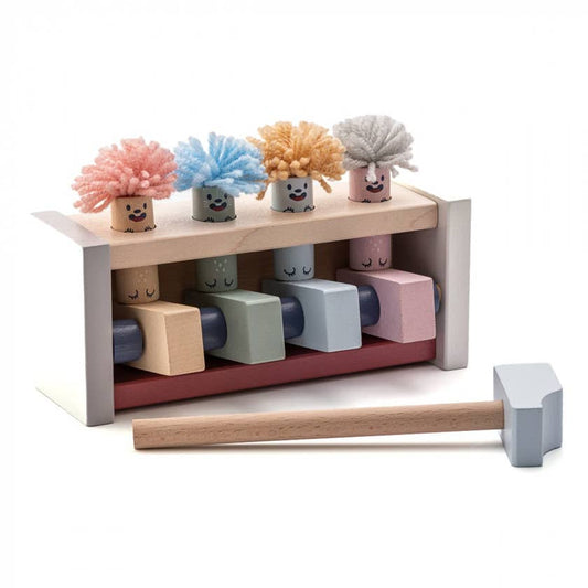 Set of colorful foam dusters with smiling faces on a wooden shelf with a hammer in front.