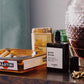 Small bottle of perfume on a wooden surface with a blurred background