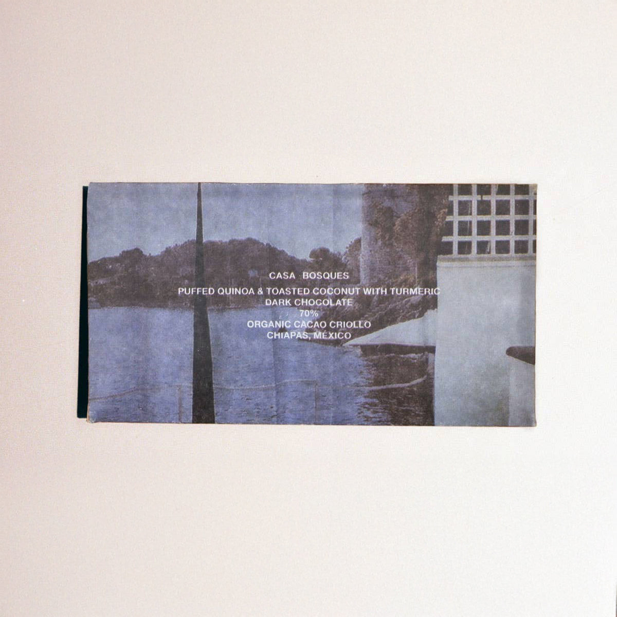 Product packaging with scenic image and text on a beige background
