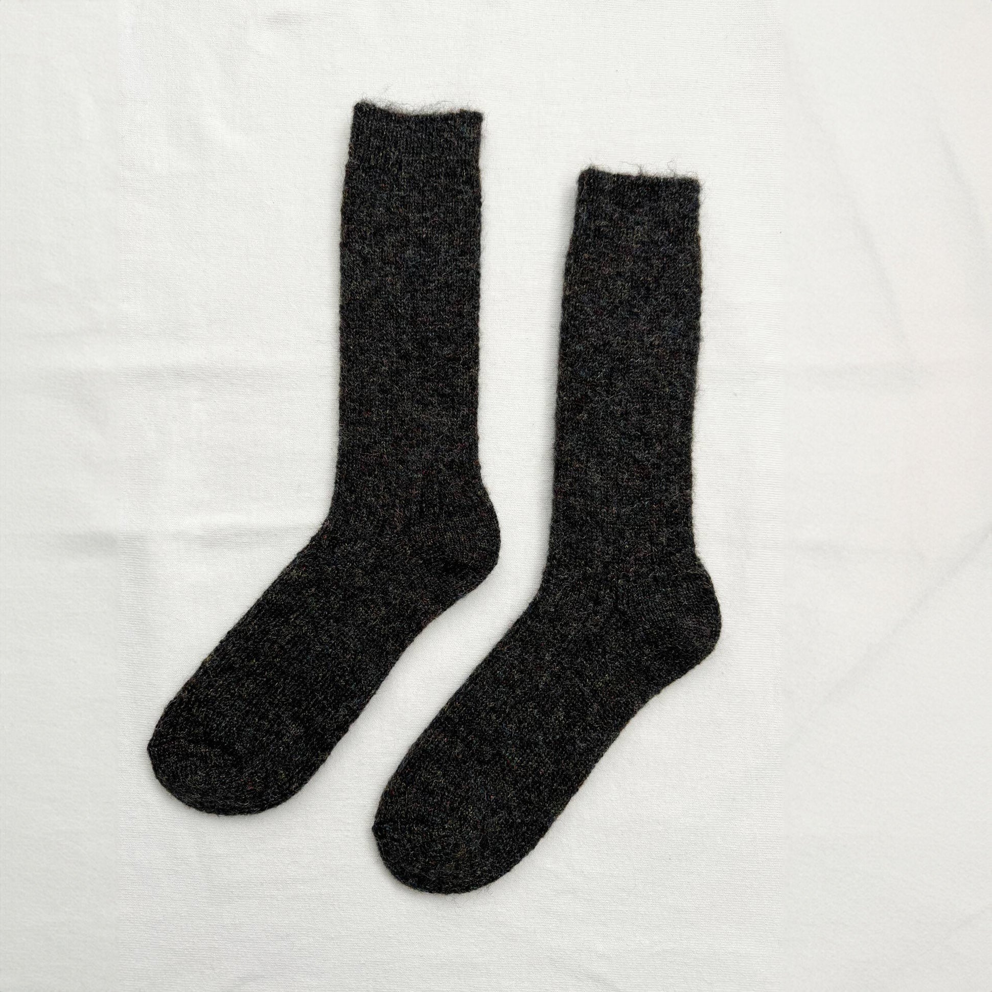 a pair of fuzzy black ankle socks with shiny sheen