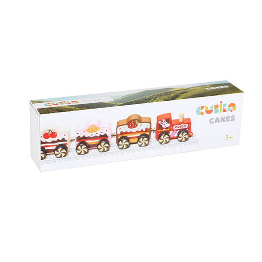 Box of toy train cars shaped like cakes with 'Kubla' branding on a white background