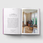 Open book showing a page with text and an image of a room with sculptures.