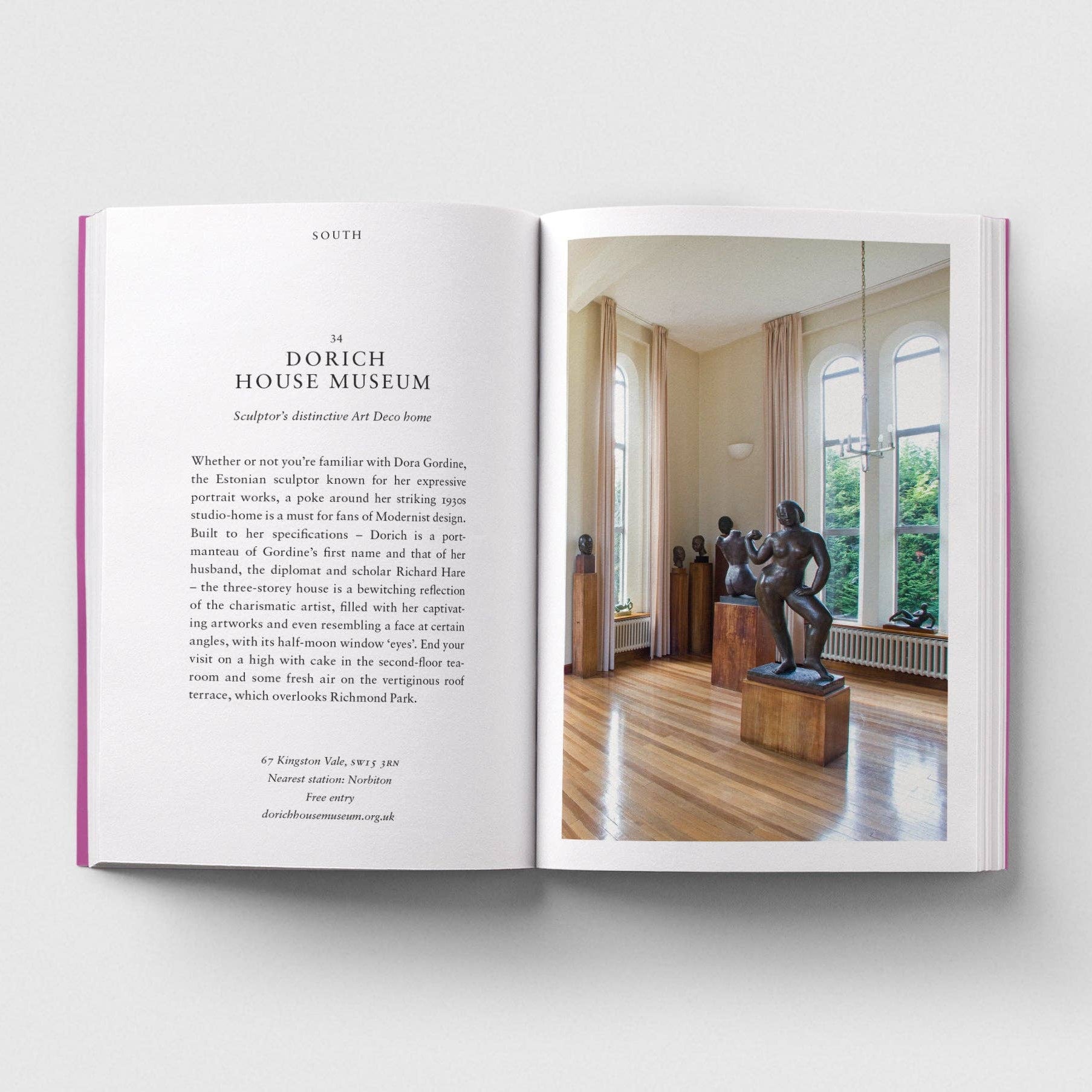 Open book showing a page with text and an image of a room with sculptures.