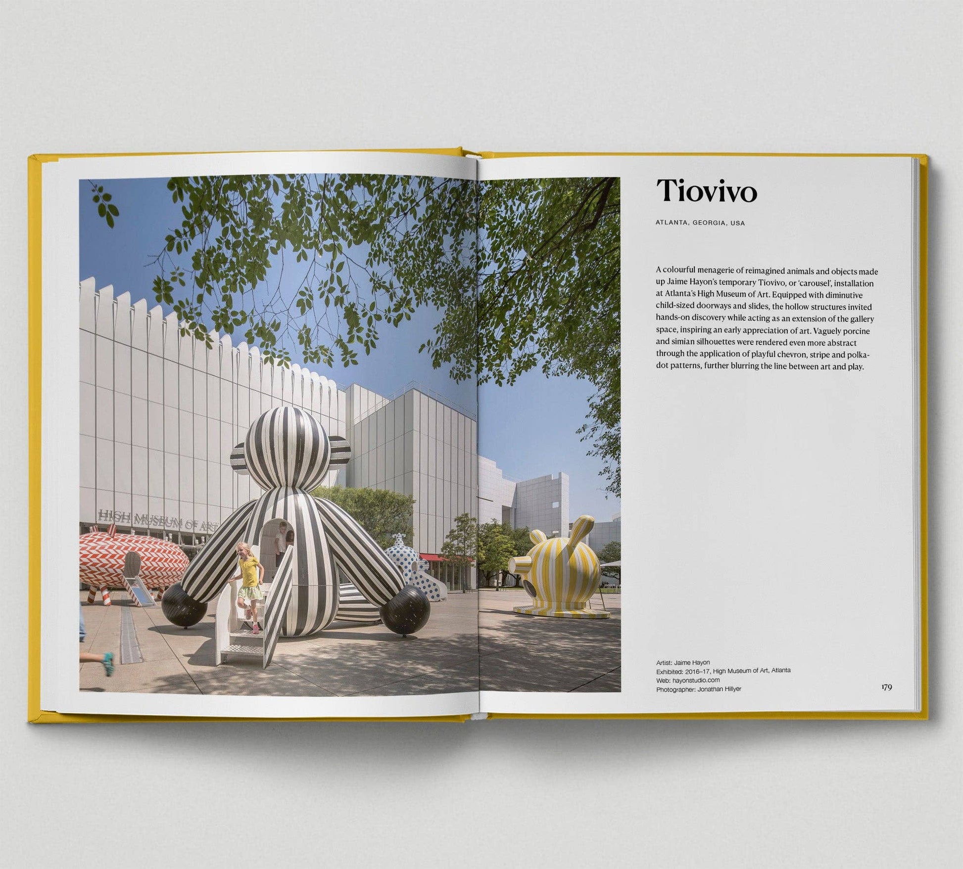 Open book showing a page with an image of a sculpture and text on a white background