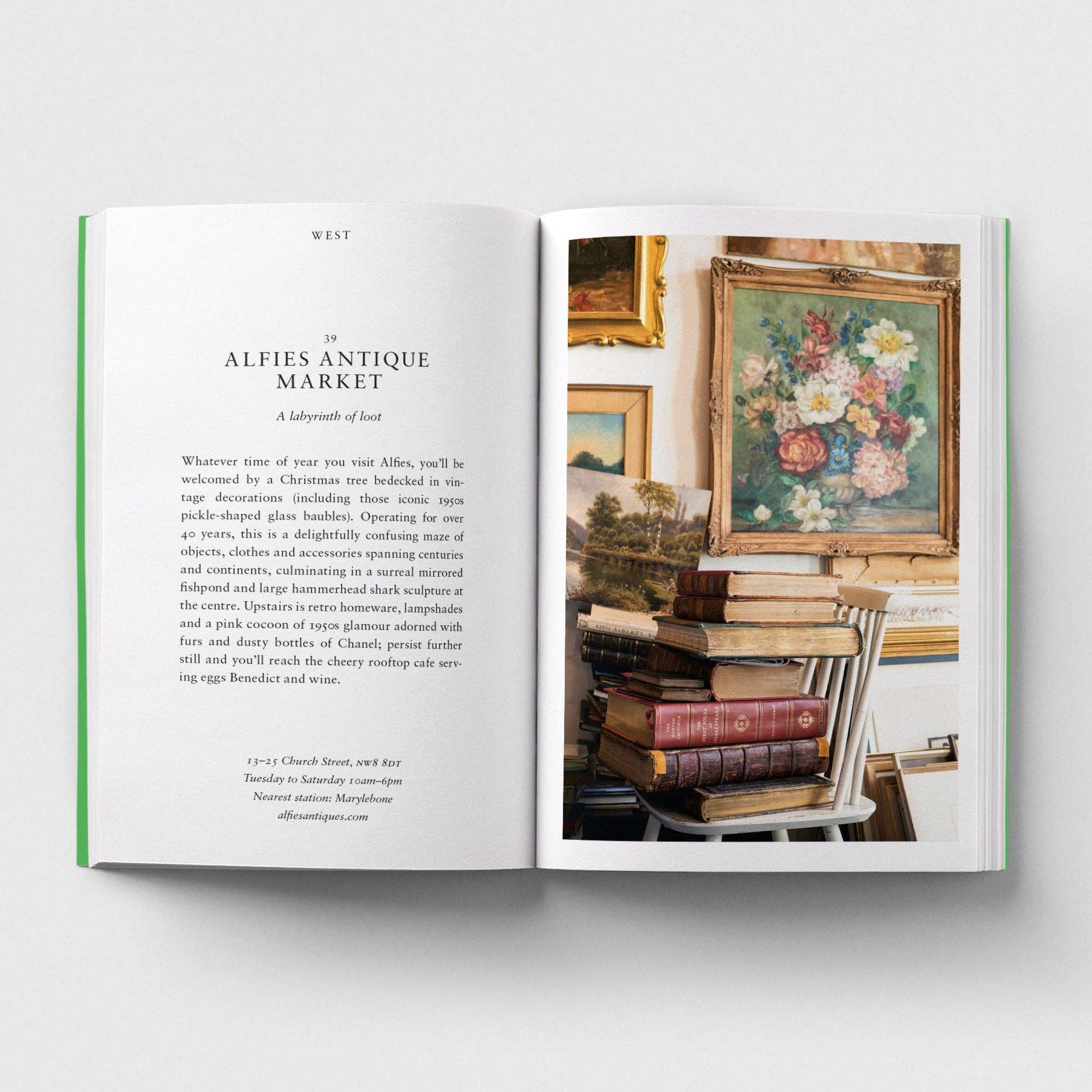 Open book showing a page with text and an image of a floral painting and books.