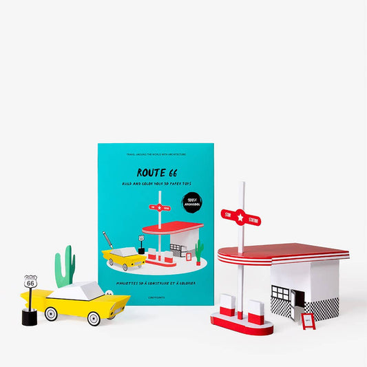 Model of a gas station with a book titled 'ROUTE 66' on a white background