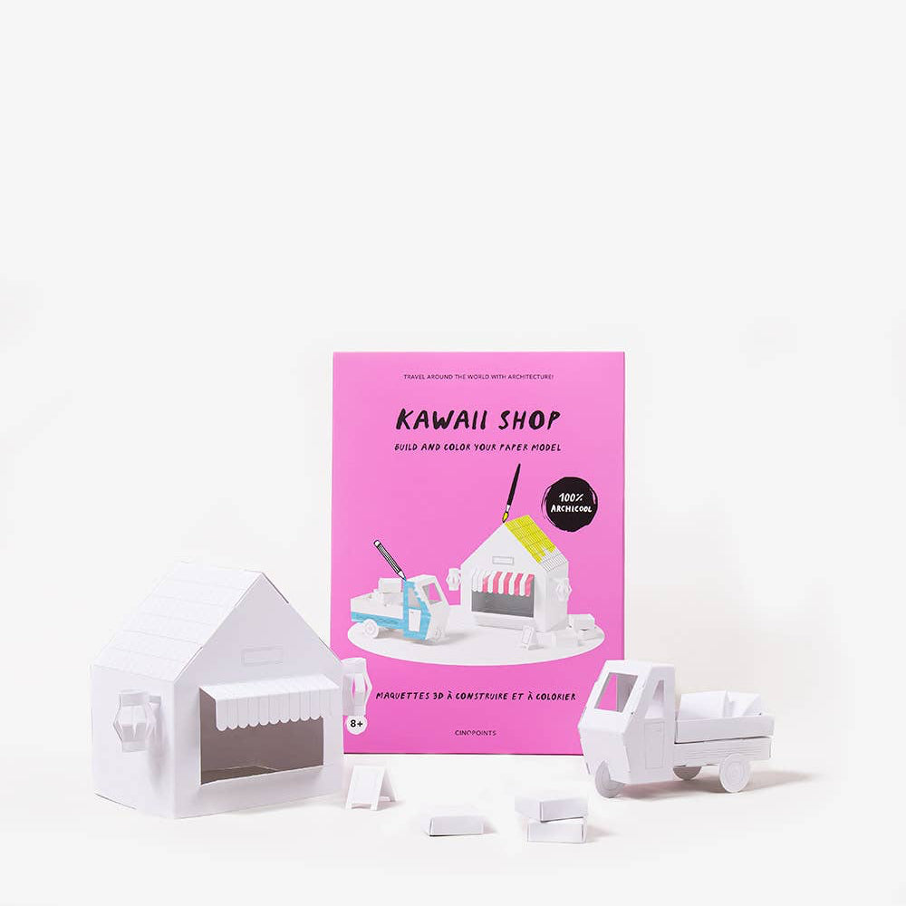 Small white robot-like figure with a pink book titled 'Kawaii Shop' on a white background