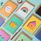 Colorful greeting cards with various designs on a light blue background