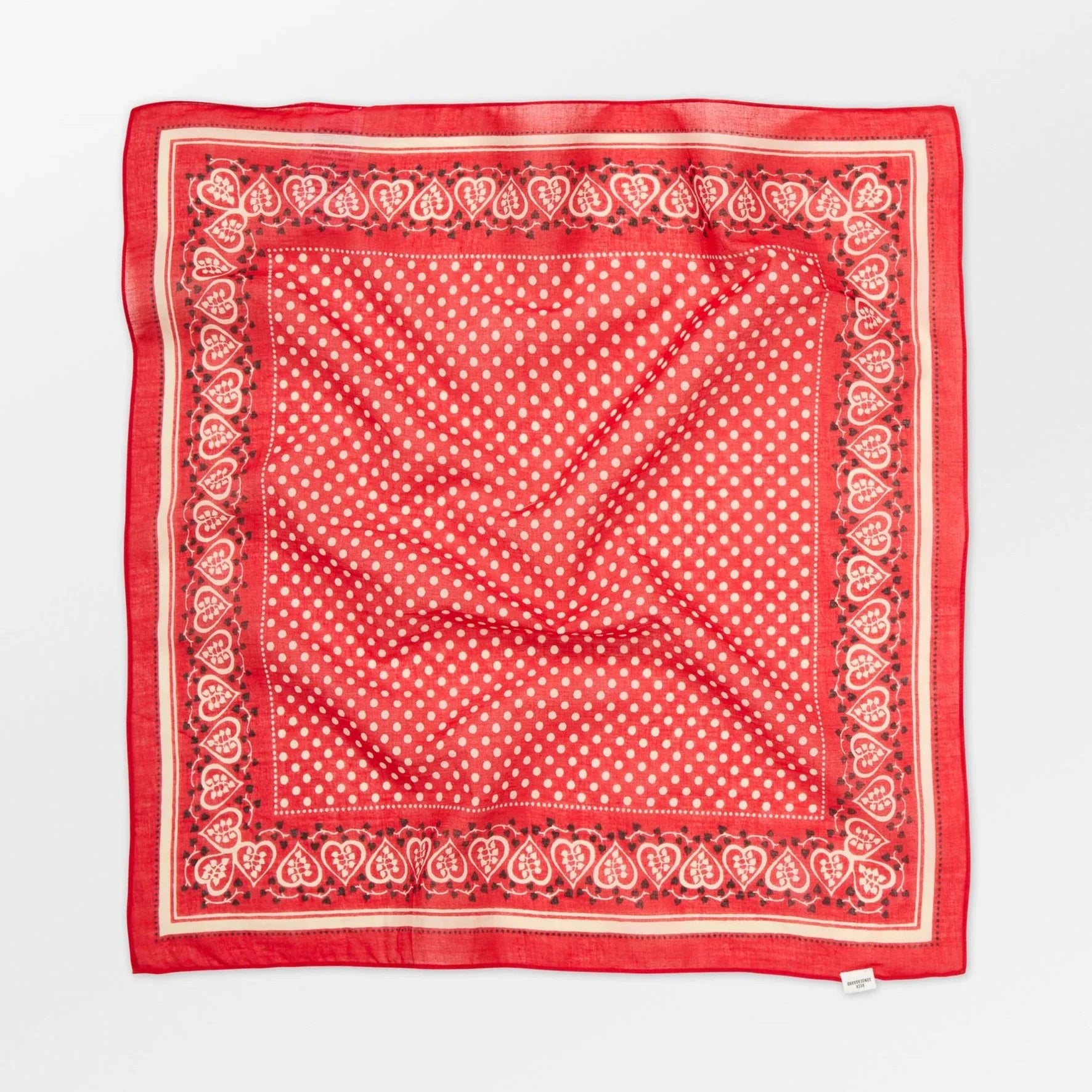 Red bandana with white polka dots and border on a white background