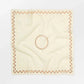 Beige square scarf with a circular pattern on a white background