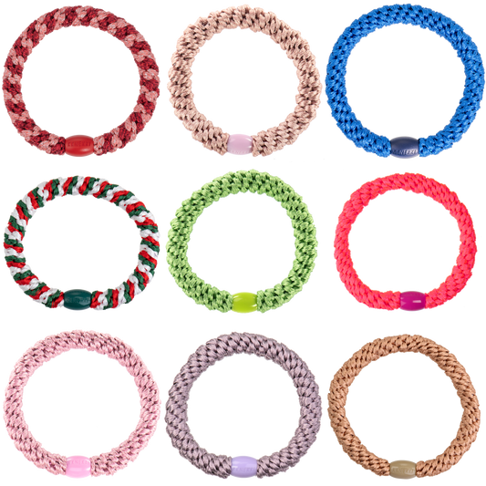 Collection of colorful braided bracelets on a white background