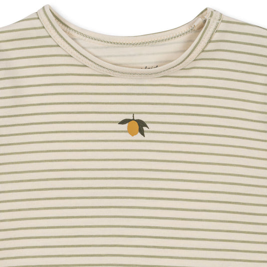 Close-up of a Konges Sløjd striped onesie, showing a small citrus fruit print on the chest. The neckline features soft stitching for comfort.