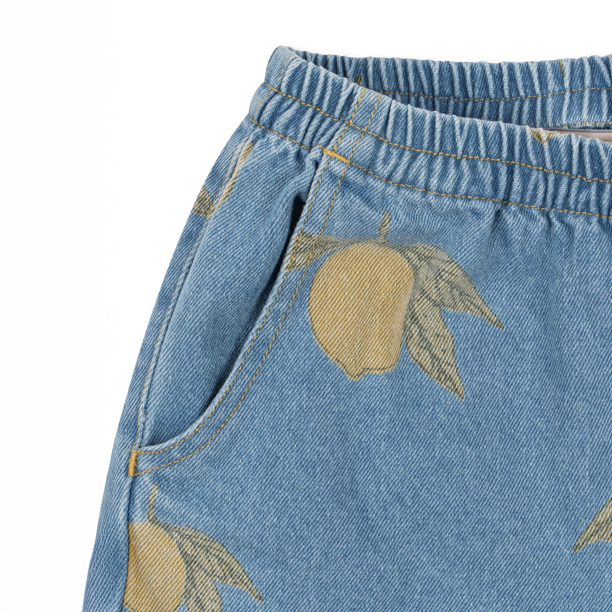 A closer look at the Magot Pants’ gathered waistband and side pocket, with the signature lemon print adding a playful touch to classic denim.