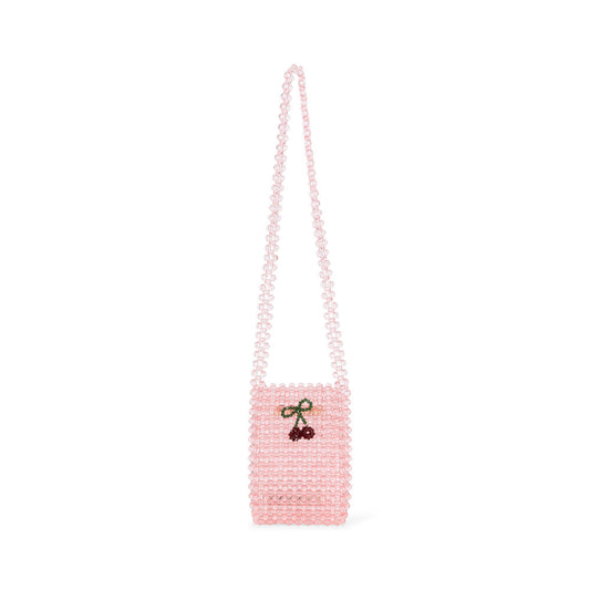 A delicate pink beaded strap wallet by Konges Sløjd. The small crossbody bag is made entirely of translucent pink beads, with a long beaded strap. A cherry motif, crafted from red and green beads, is embroidered onto the front, adding a playful detail. The compact size makes it perfect for carrying small essentials.