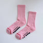 Pink socks with text on a white background