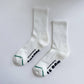 White socks with text on a light gray background