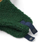 Green fleece blanket with blue trim on a white background