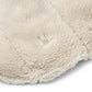 Close-up of a textured cream balaclava on a white background