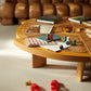 Wooden coffee table with board games and books in a living room setting