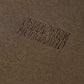 Brown fabric with embroidered text 'NORGAARD NORGAAARD' on a brown background