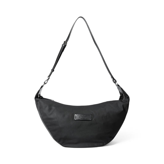 Black shoulder bag with a visible Mads Norgaard label on a white background
