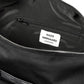 Close-up of a black bag interior with Mads Nørgaard label