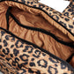 Leopard print bag with open top showing interior.