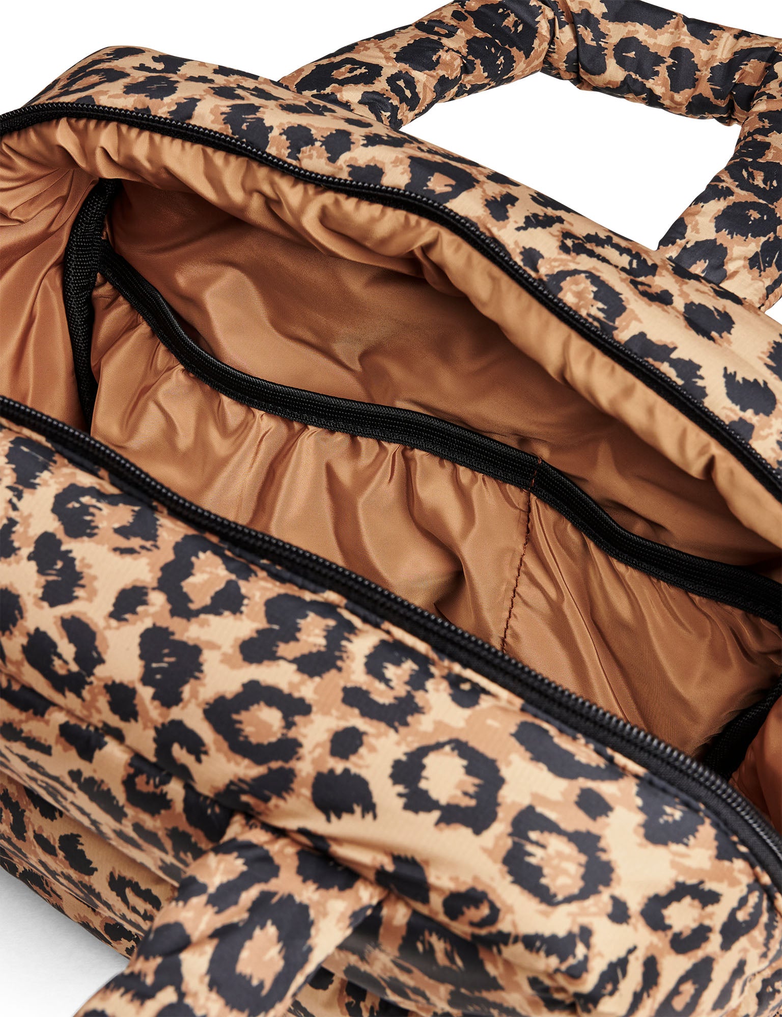 Leopard print bag with open top showing interior.