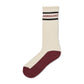 An off white sock with burgundy heel and sole and 'Norgaard' branding on a white background