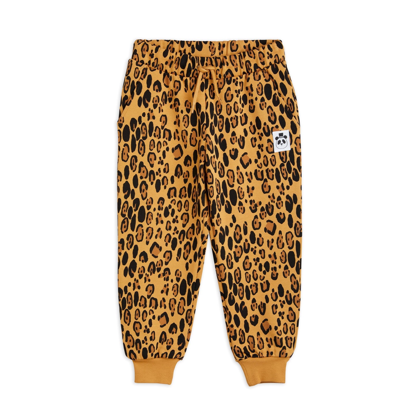 Mini Rodini sweatpants in an abstract leopard print all over pattern. on a beige base there is darker brown and black leopard pattern spots and a drawstring elastic waistband and pinched cuffs at the ankles