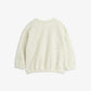 White knitted sweater on a light beige background