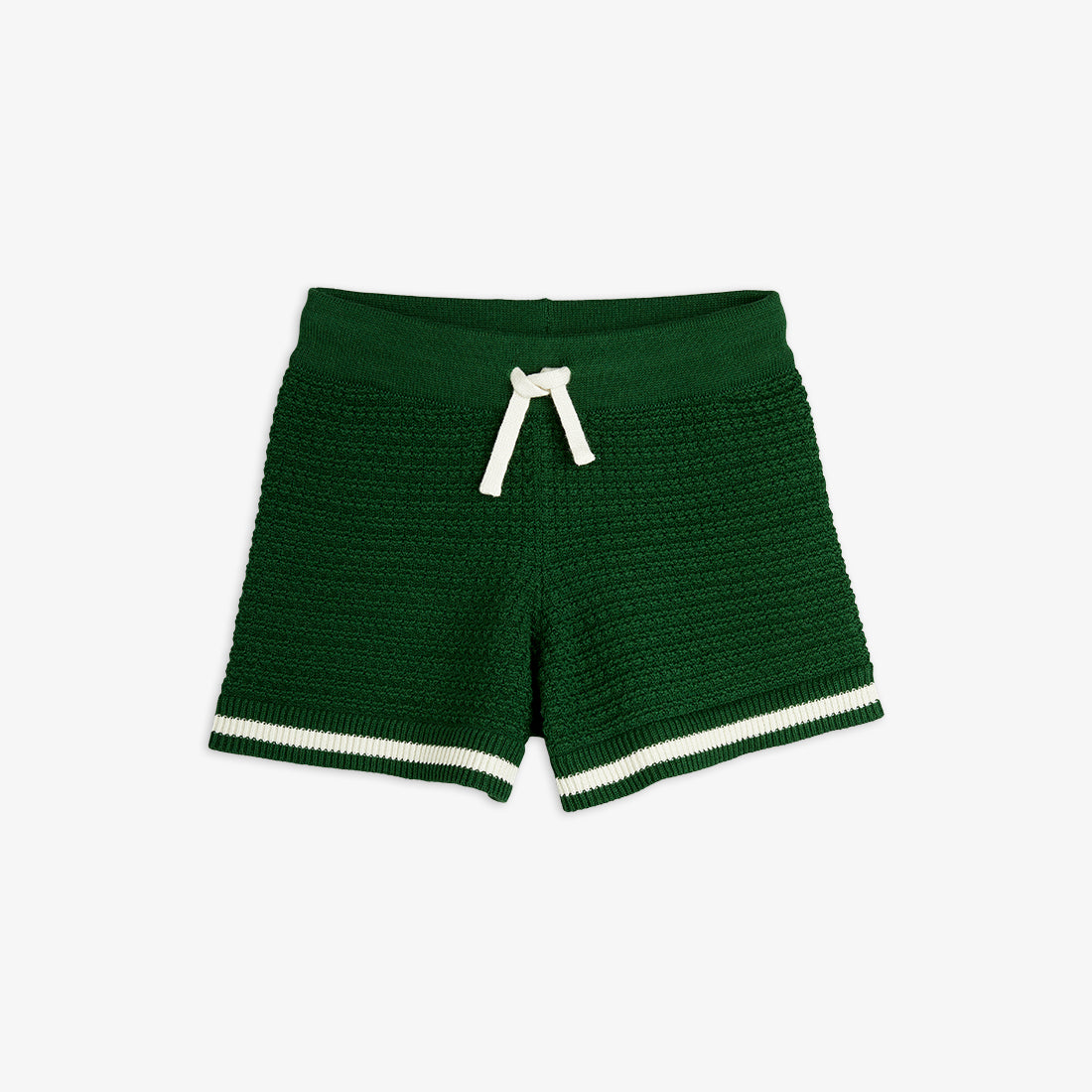 A pair of Mini Rodini crochet knit shorts in deep green. These stylish knitted shorts feature a textured crochet pattern, a comfortable elastic waistband with a cream-coloured drawstring, and contrasting cream and green striped hems. A soft and breathable choice for warm-weather outfits.