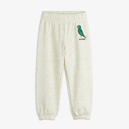 Cream-colored sweatpants with a green bird logo on a white background
