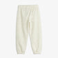 Cream-colored baby pants on a white background