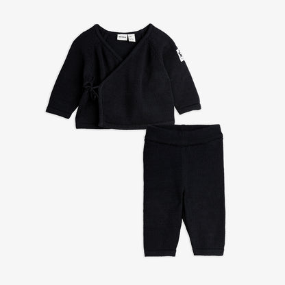 Black baby outfit with top and pants on a white background