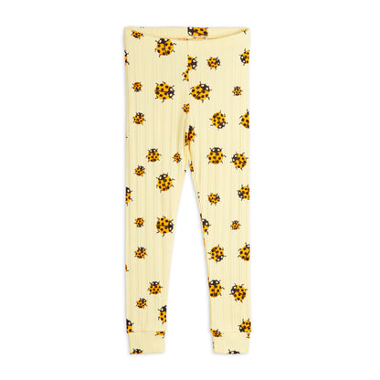 A pair of ribbed, cream-coloured children's leggings featuring an all-over print of orange and black ladybirds. The leggings have an elastic waistband and cuffed ankles.