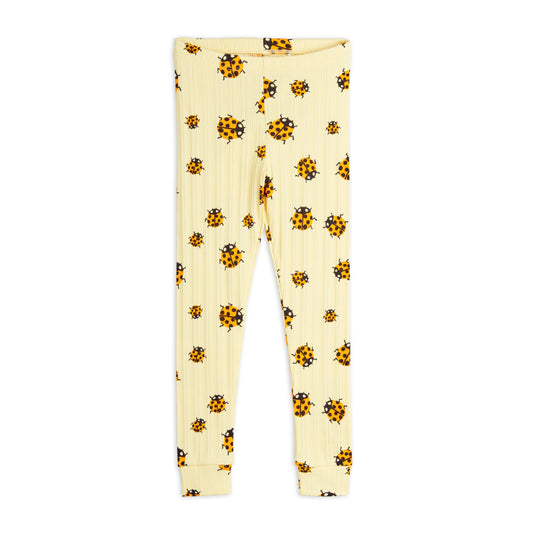 A pair of ribbed, cream-coloured children's leggings featuring an all-over print of orange and black ladybirds. The leggings have an elastic waistband and cuffed ankles.