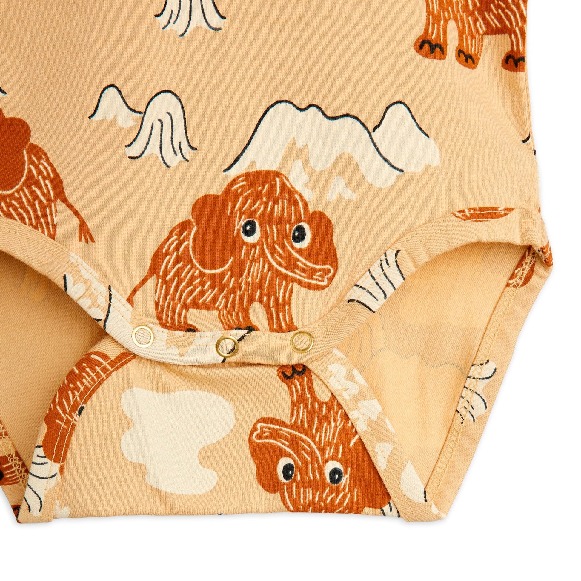 Close-up of a fabric with mammoth pattern on a beige background on a baby body