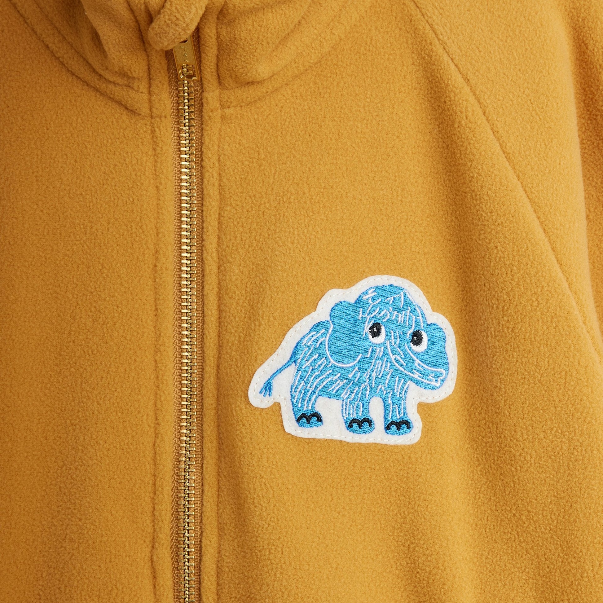 Yellow jacket with a blue and white mammoth patch on the chest