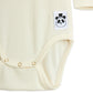 Close-up of a cream-colored baby bodysuit with a panda logo tag on a white background