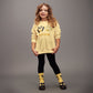 Child wearing a yellow sweater with cartoon characters and text on a gray background