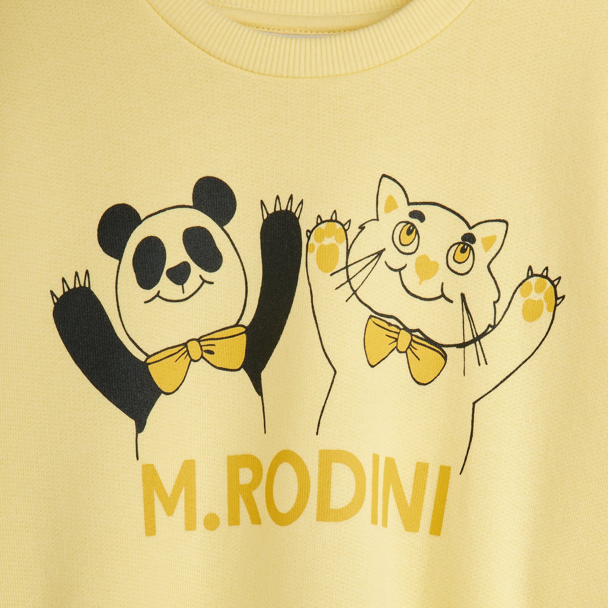 Yellow shirt with cartoon panda and cat design and 'M. Rodini' branding.